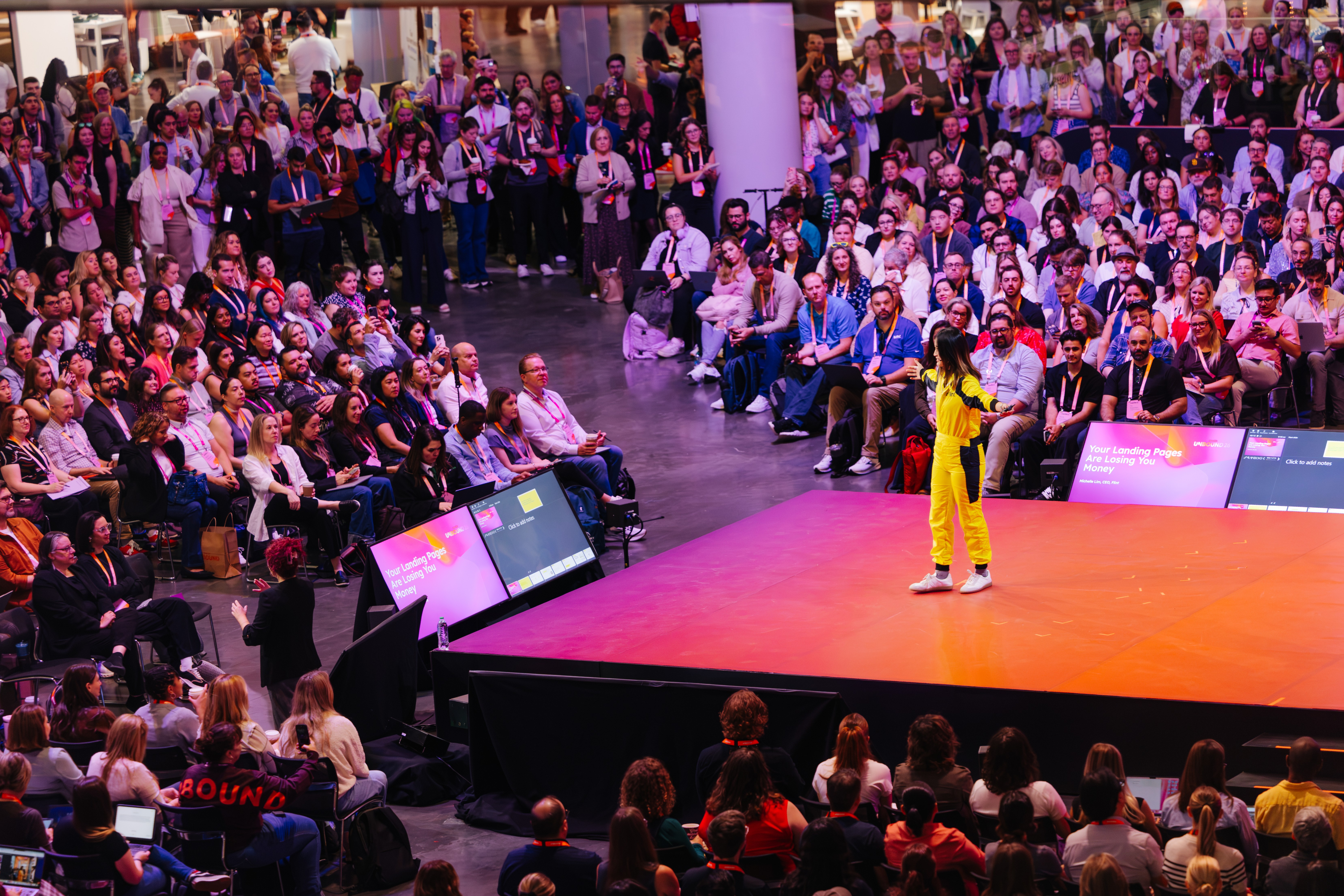 Michelle Lim speaking on stage to a packed audience at UNBOUND 2026
