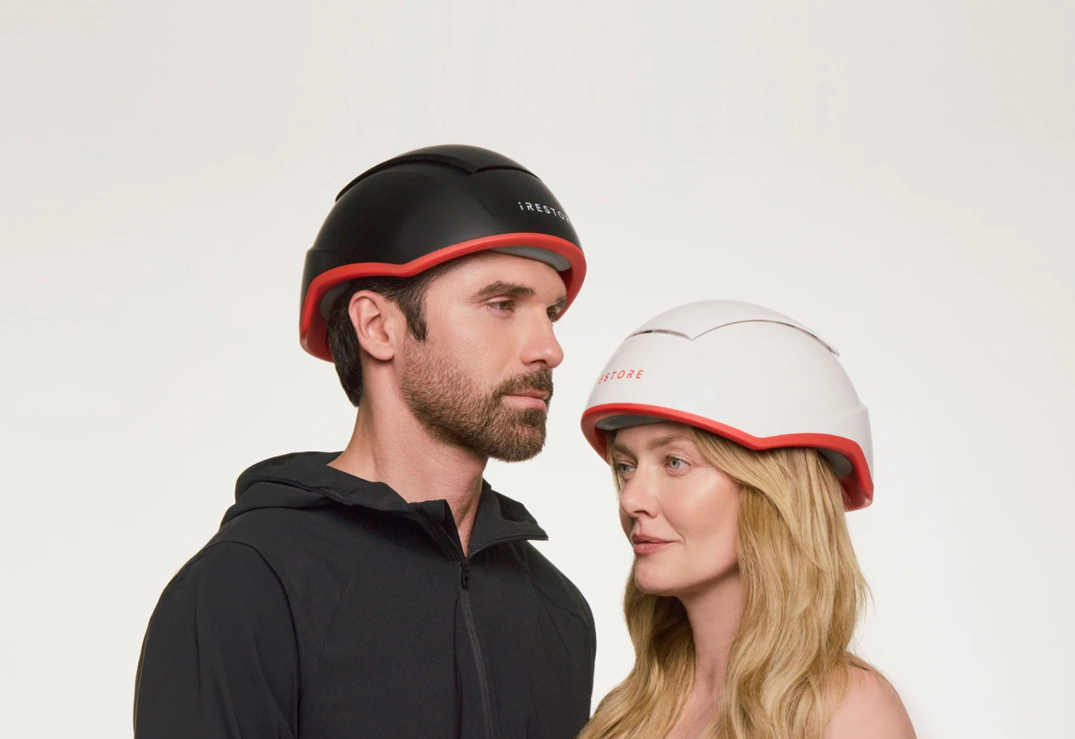 Couple wearing iRESTORE hair growth helmets