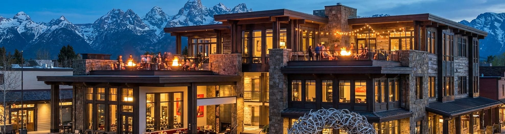 Cloudveil Autograph Collection hotel exterior at dusk with rooftop fire pits, contemporary mountain architecture
