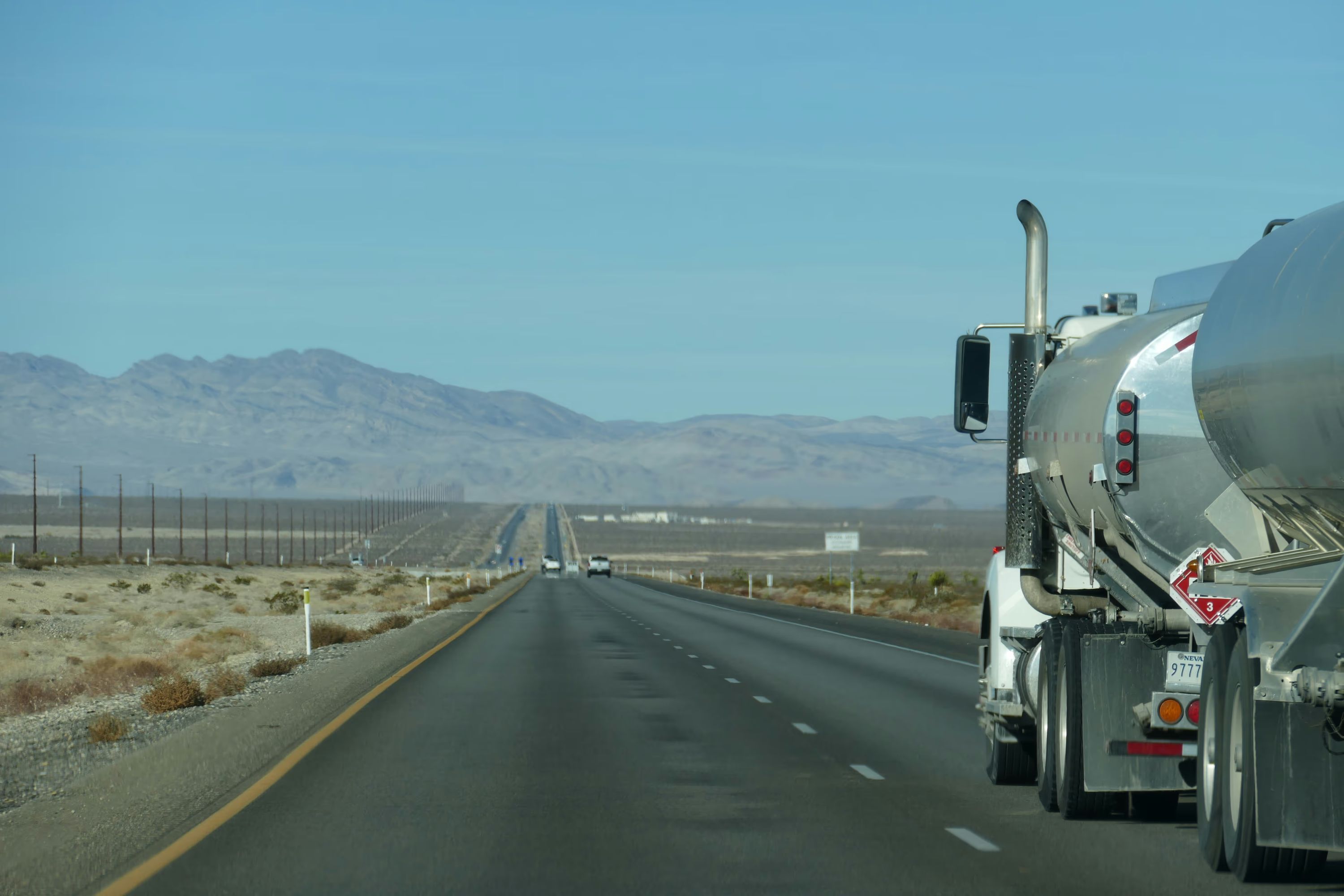 A freight truck crossing a desert highway