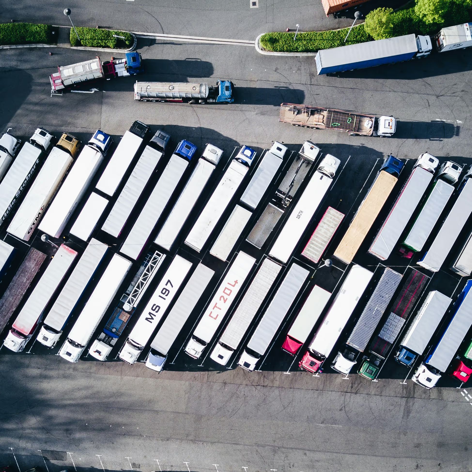 Semi-trailers and trucks at a busy freight yard