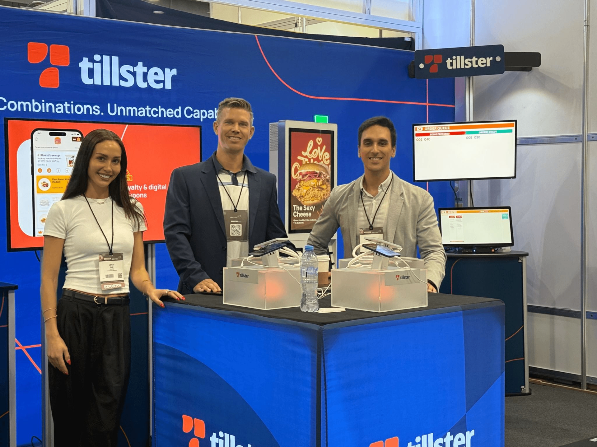 Tillster team welcoming visitors at an exhibition booth