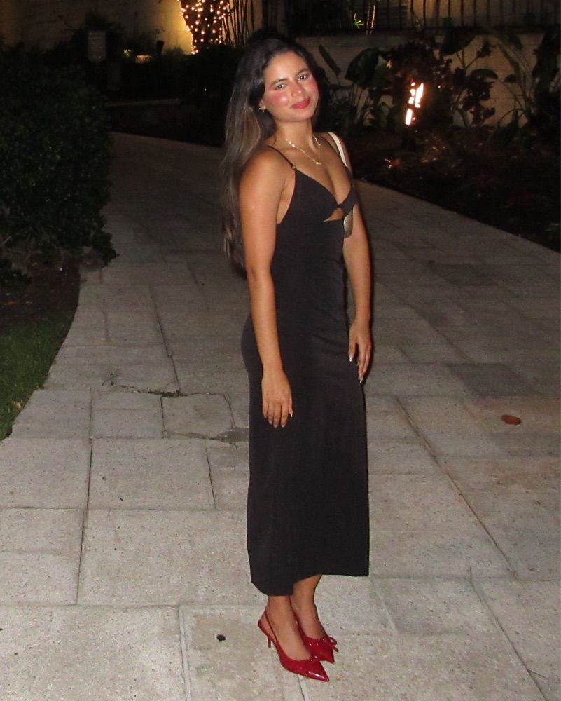 Black cutout Zara dress and red heels photographed at night