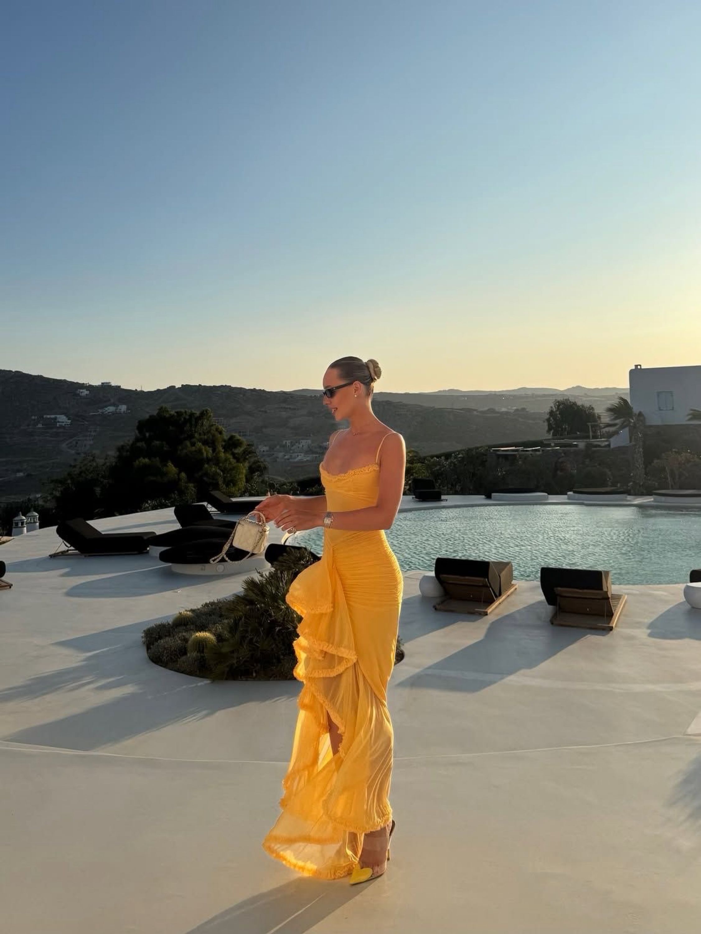 House of CB Gabbi gown in apricot beside a pool