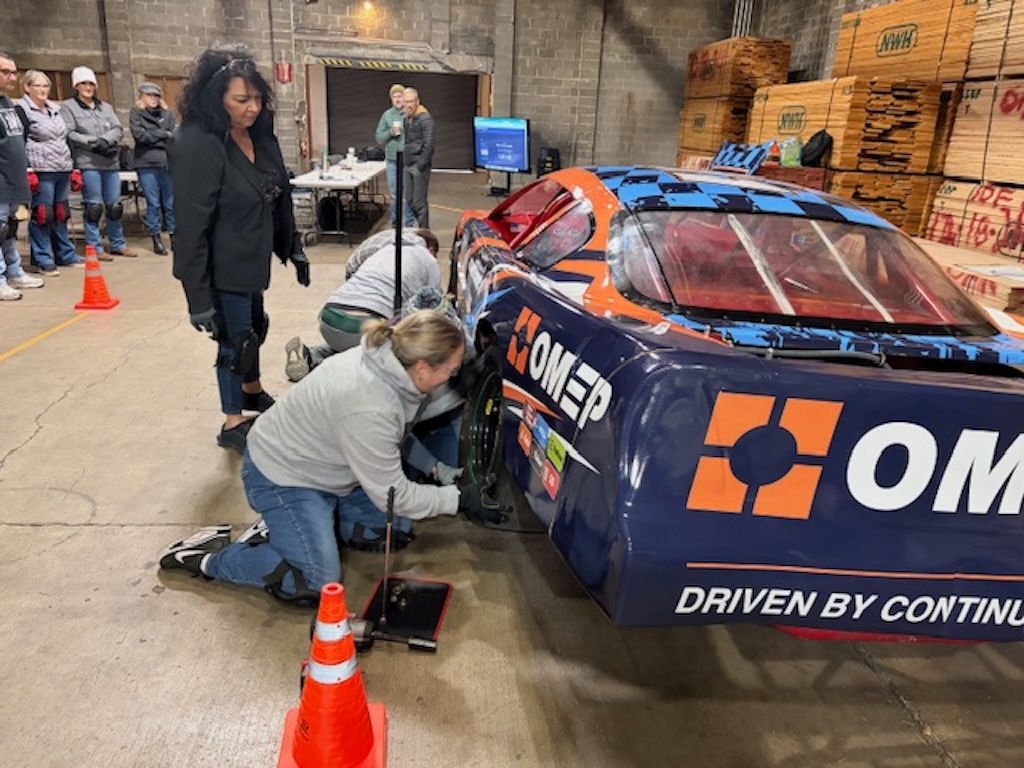 Team changing a tire during the Pit Crew Challenge team learning event