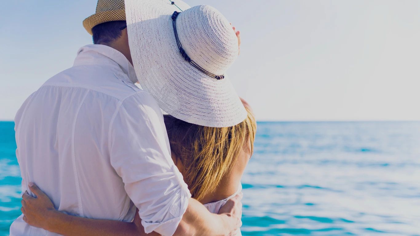 A couple embracing on the beach near the ocean