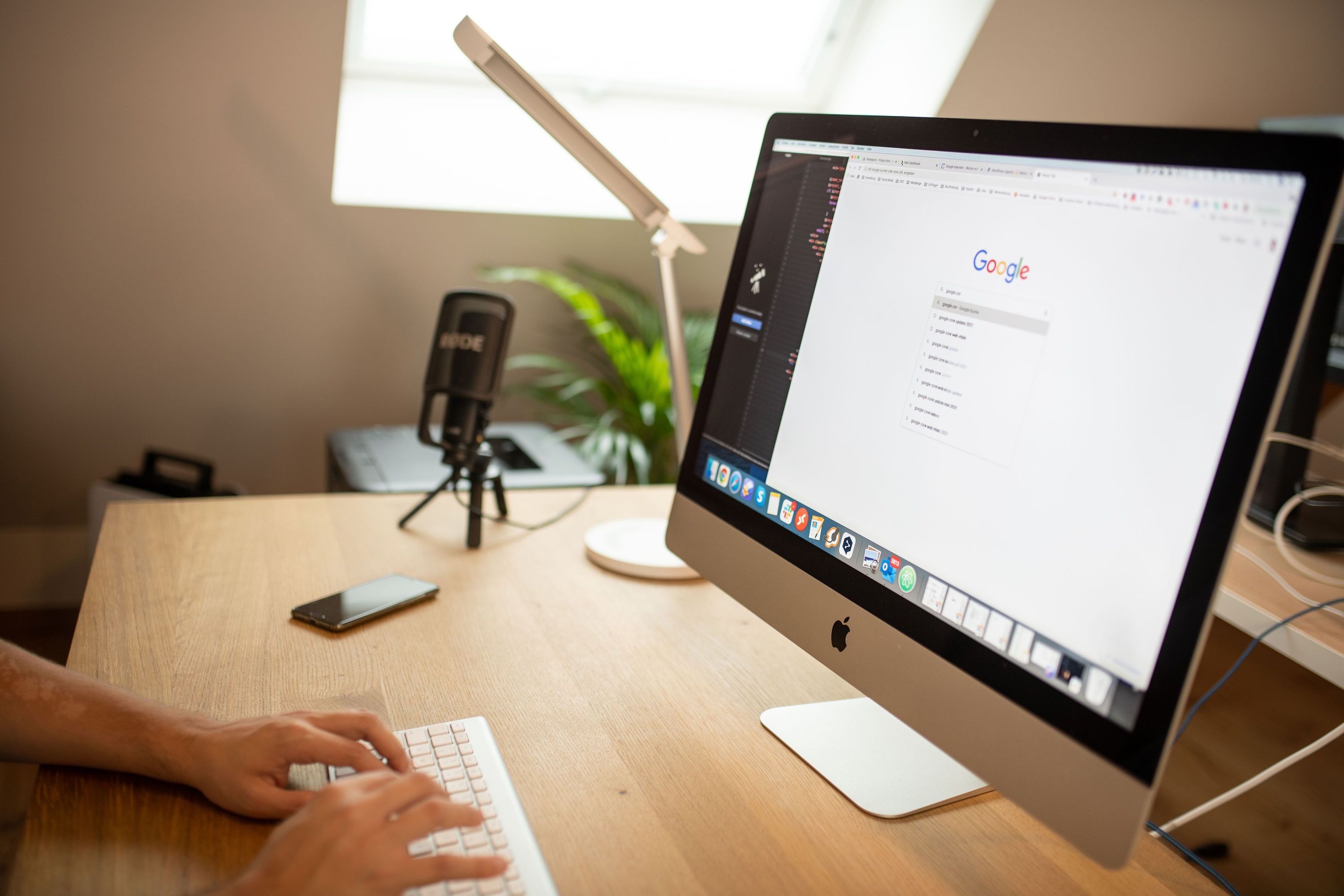 A home office desk with Google displayed on a desktop computer