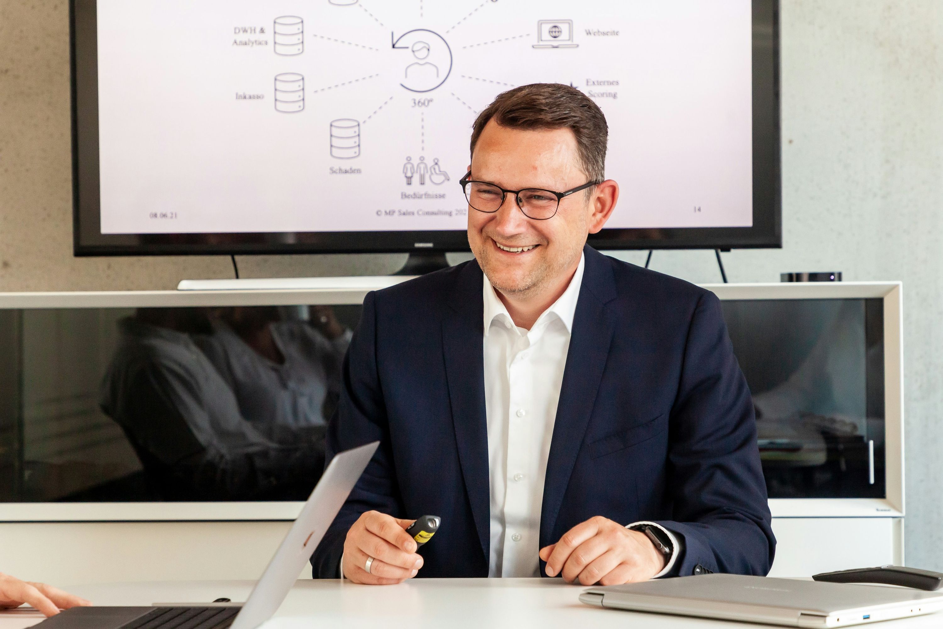 Businessman smiling in front of a sales funnel diagram