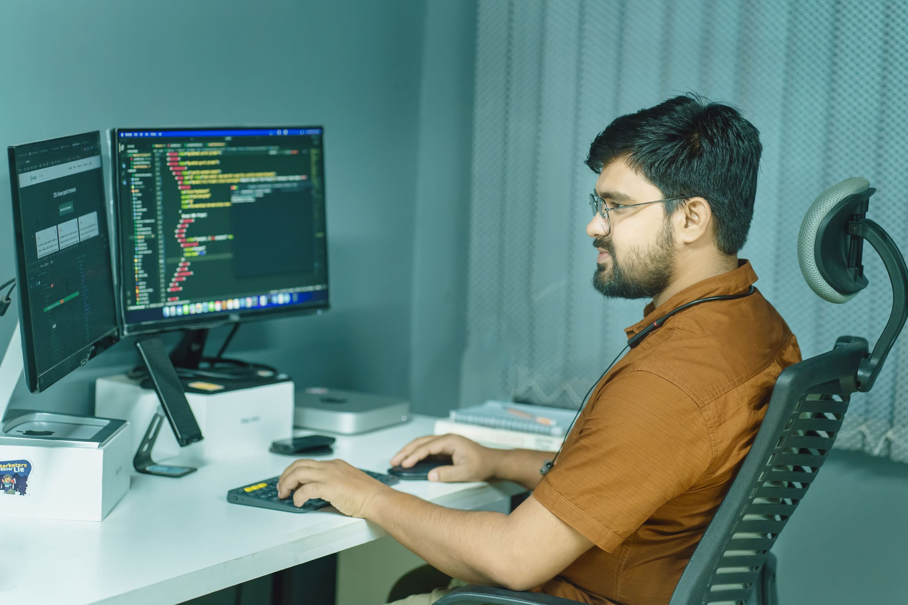 Software developer working at a multi-monitor workstation