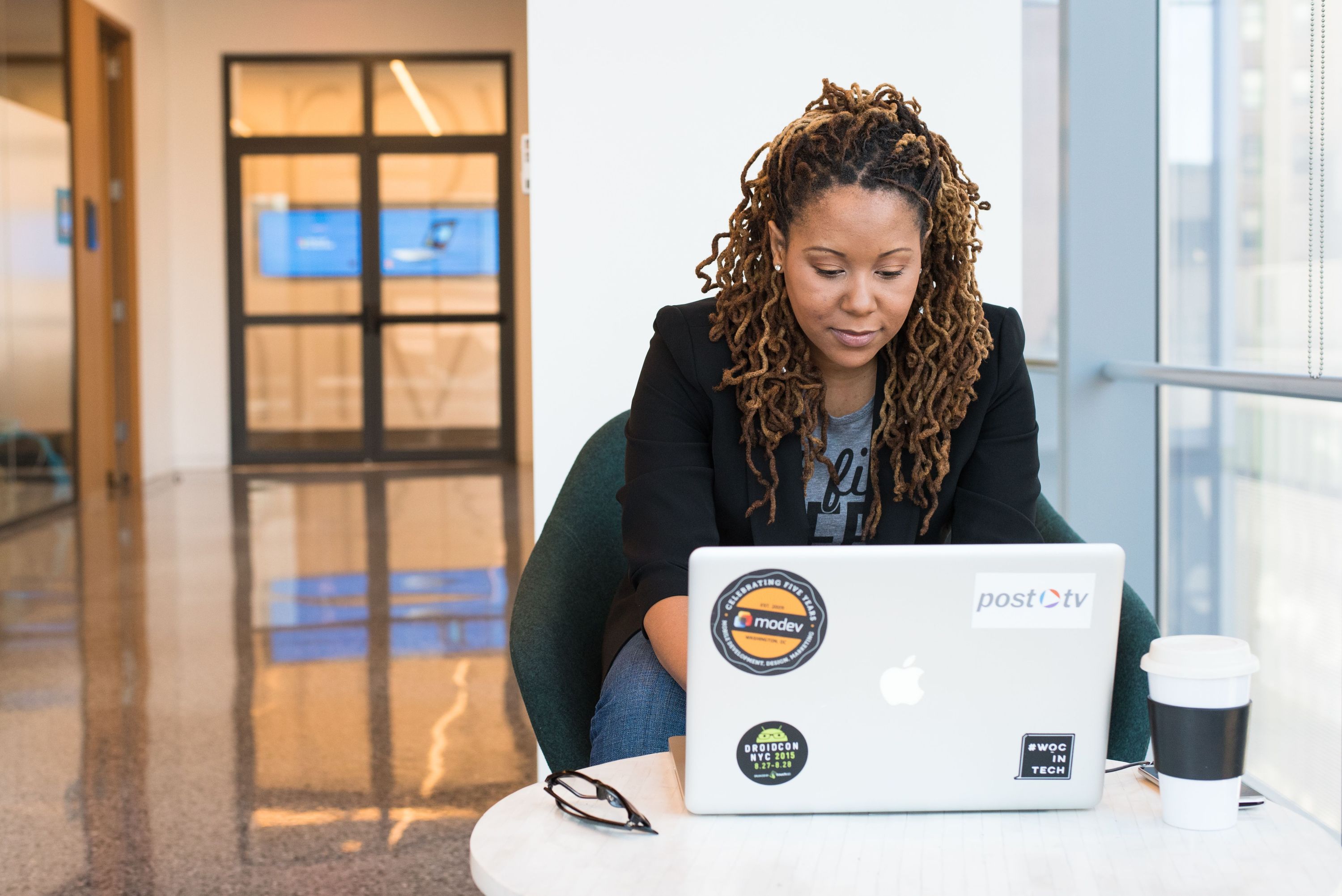 Marketer working on a laptop in a modern workspace