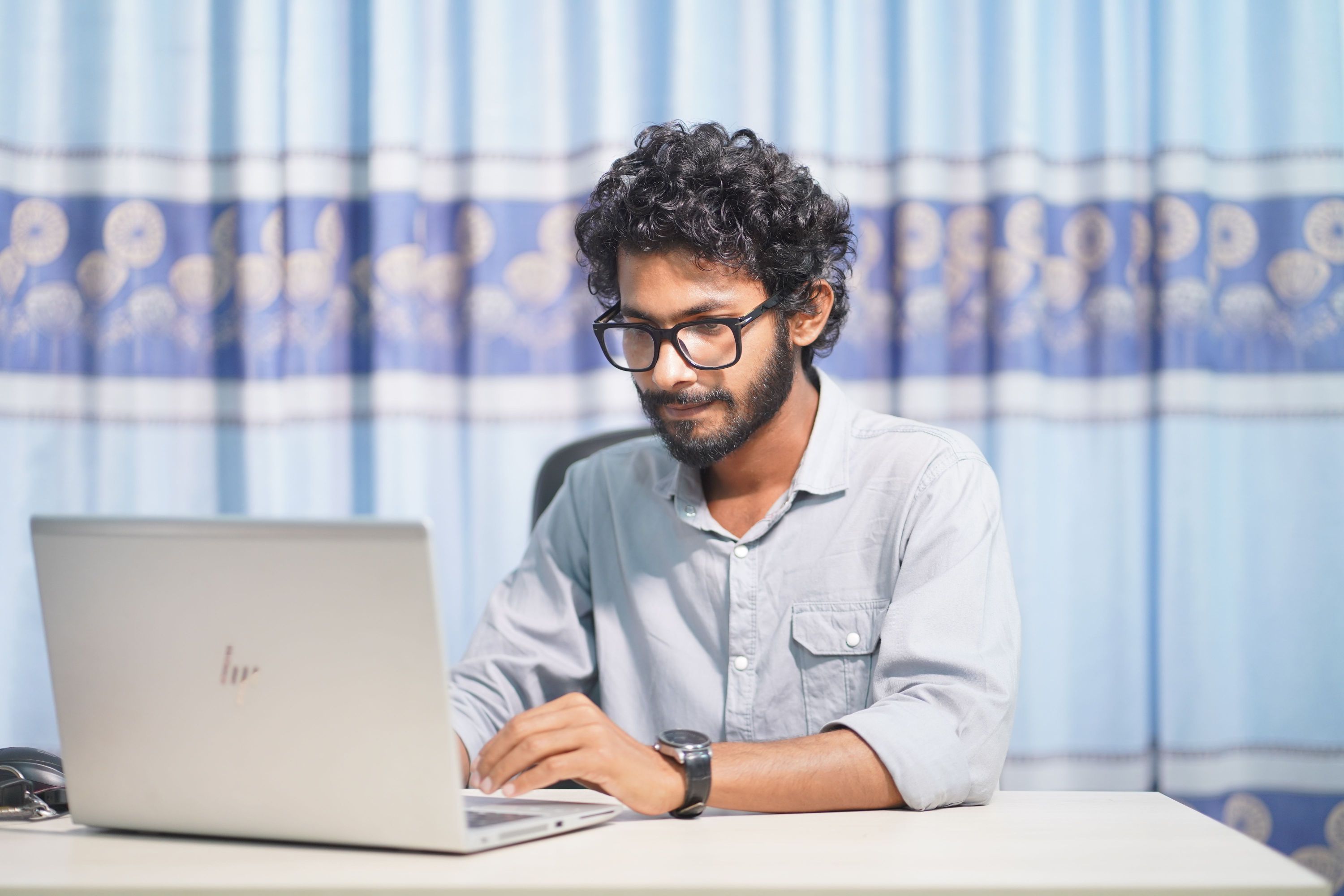 Professional working on a laptop at a desk